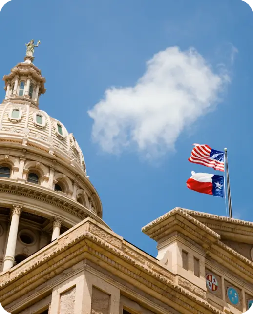 Texas State Capitol with Texas and U.S. flags.
