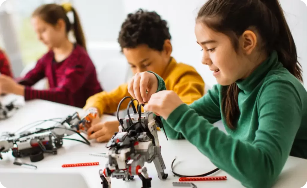 Students building robots in a classroom.