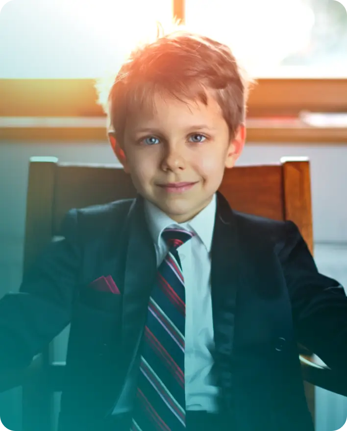 Young boy dressed in a suit and tie.