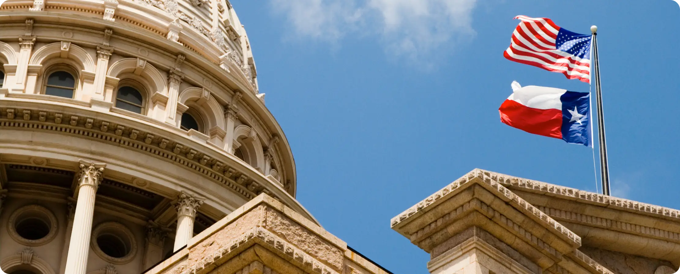 Texas State Capitol with Texas and U.S. flags.